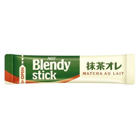 A single AGF Blendy Stick packet, torn open with the matcha powder visible, next to a mug.
