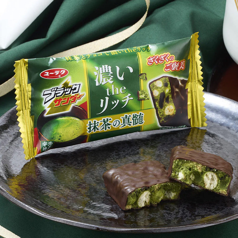 Close-up of Black Thunder Matcha Essence bar with foamy matcha and cookie crunch