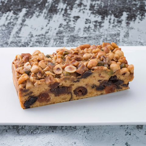 Close-up slice showing rich dried fruits and nuts inside pound cake