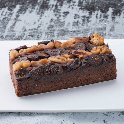 Slice of Japanese chocolate pound cake with figs and walnuts texture close-up