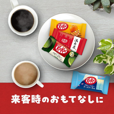 A colorful flat lay of 70 assorted Japanese KitKat minis featuring unique flavors like Matcha, Hojicha, and Strawberry Cheesecake.