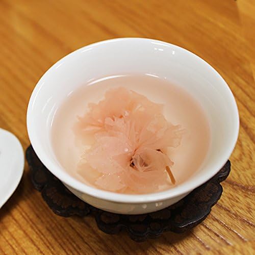 Traditional Japanese cup serving sakura tea with opened blossom