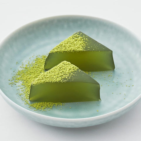 Close-up of wasanbon and Uji matcha warabi mochi with kinako powder
